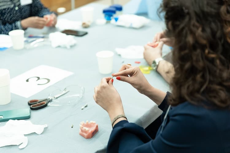 single unit implant restorations event delegates A dentist follows instructions to restore an implant
