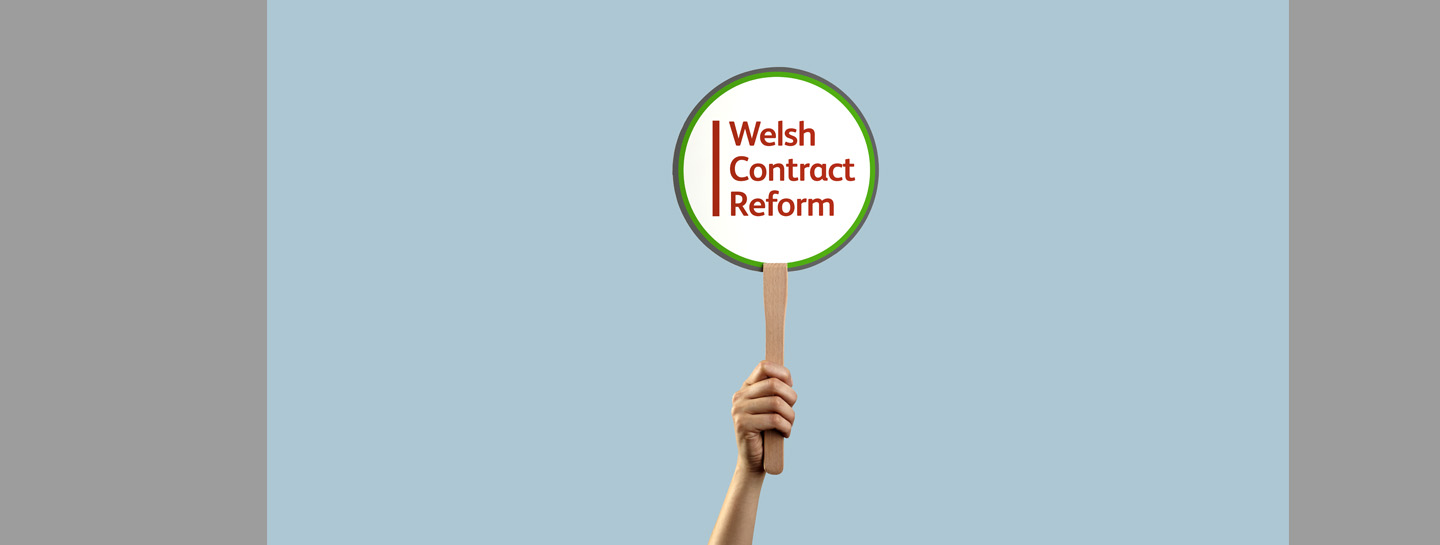WCR Standard Header 1440X545px V2 An arm holding up a white, red and green placard reading 'Welsh Content Reform' against a blue backdrop