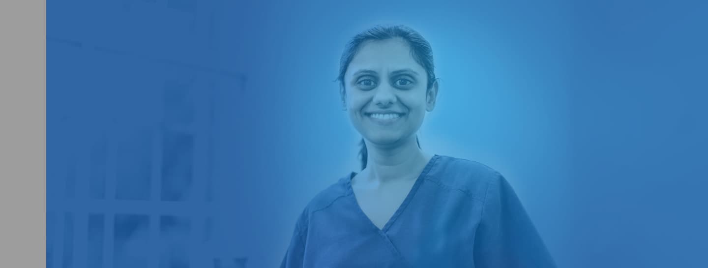 Finances ADVICE Standard Header 1440X545px A female dentist wearing scrubs smiling into the camera