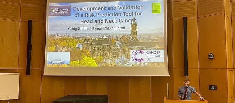 Craig Smith stands at a lectern delivering a presentation