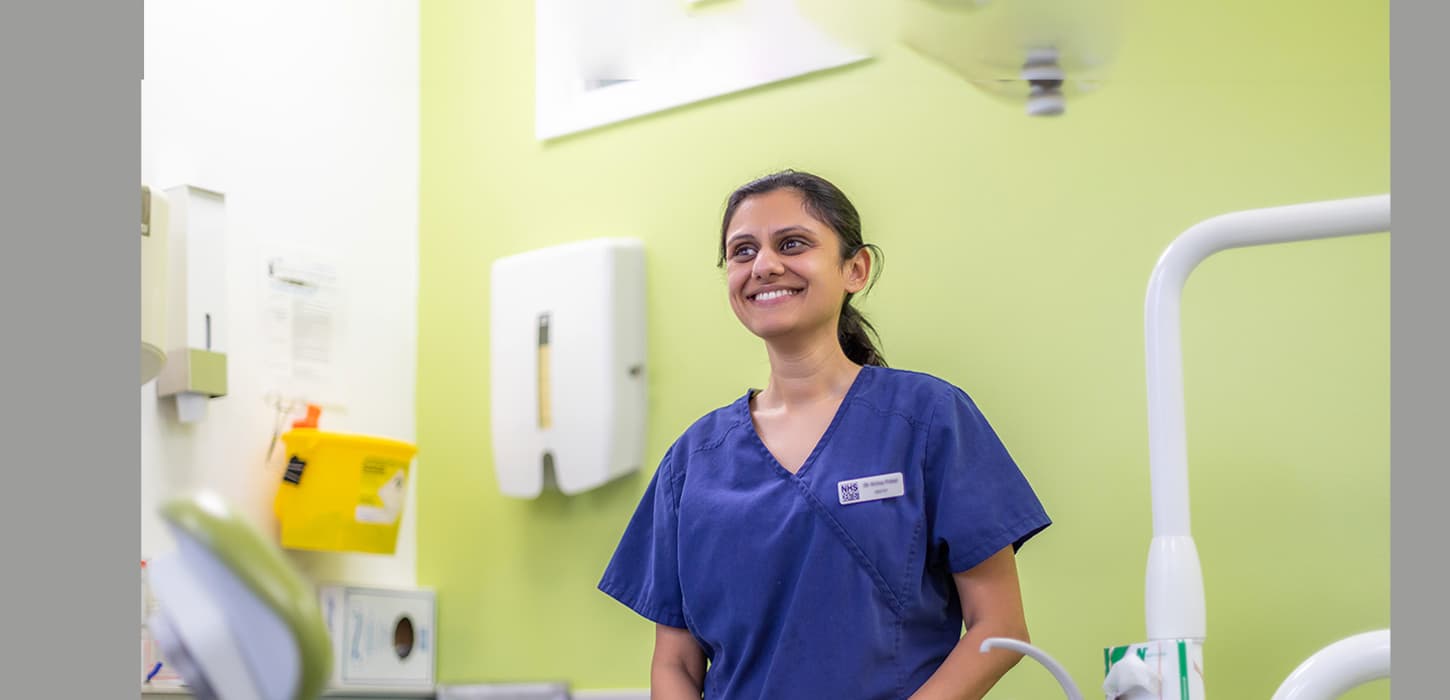 Home Hero 1440X695px Aw V3 Dental nurse in blue scrubs smiling