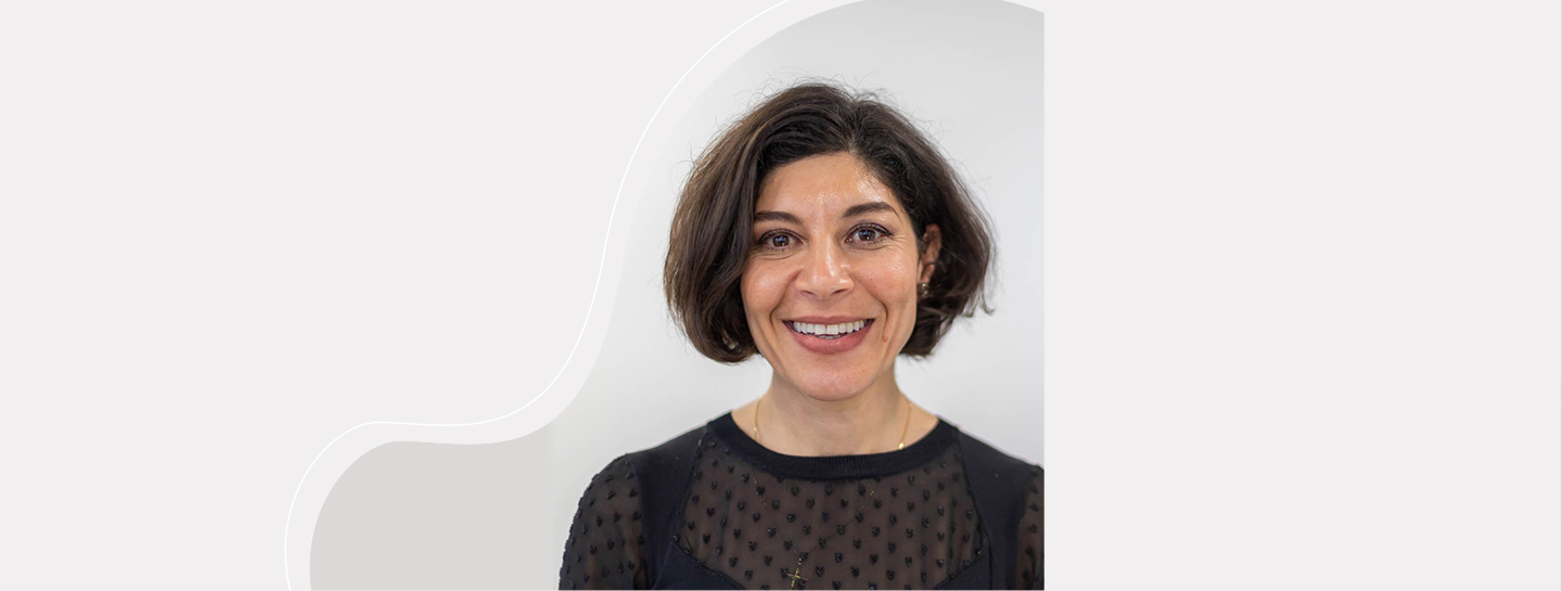 A female dental practice owner smiling into the camera