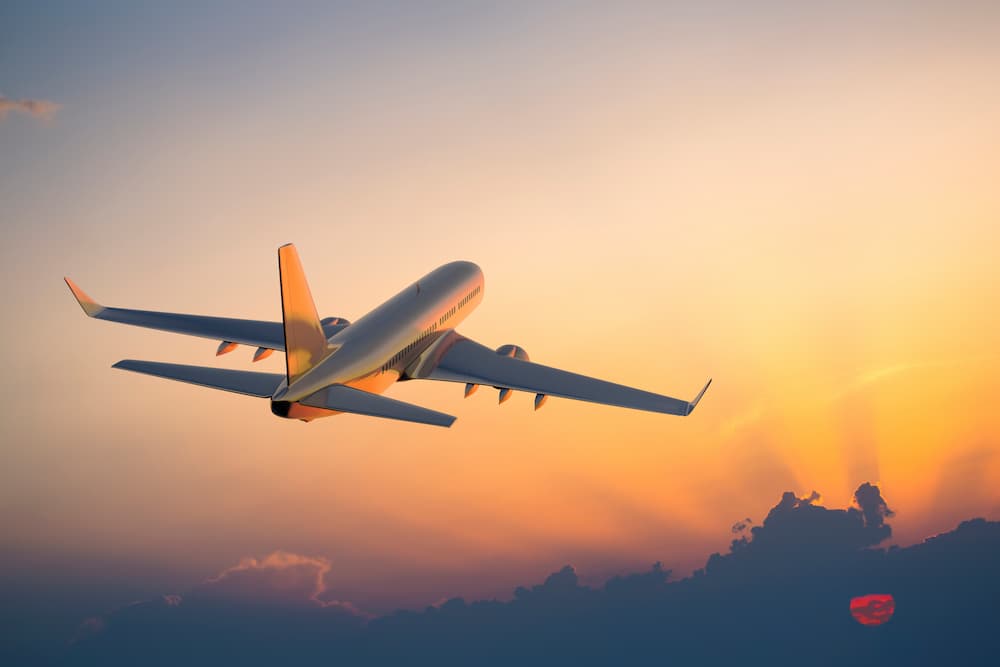 Dental tourism ad A jet plane taking off into the sunset