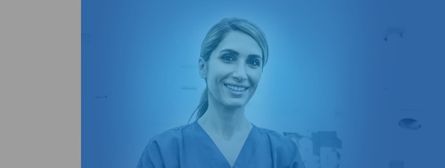 Business ADVICE Standard Header 1440X545px A female dentist wearing scrubs smiling into the camera