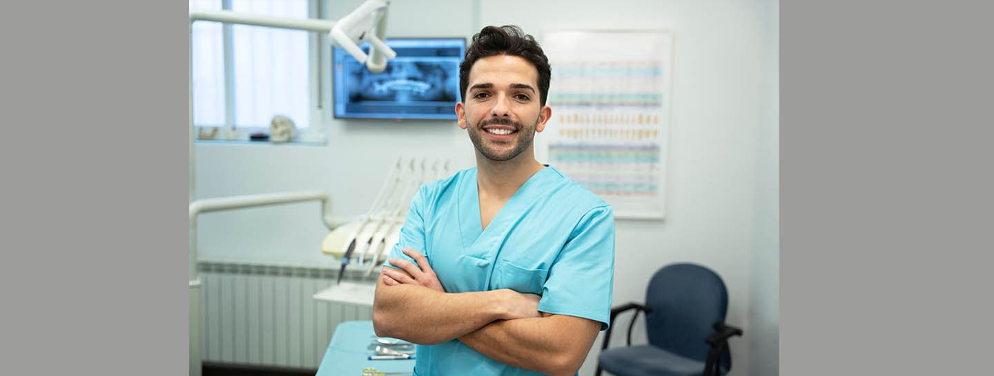 Never GDC registered hero Dentist smiling with arms crossed