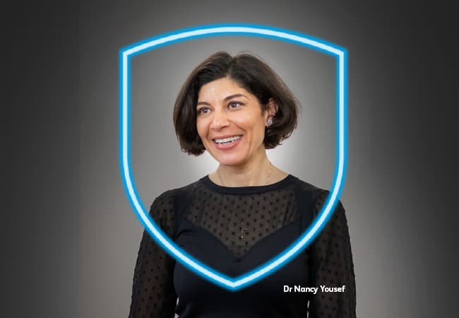 Indemnity ad - Dr Nancy Yousef Dr Nancy Yousef is smiling, protected by a blue shield
