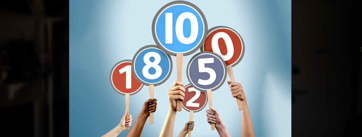 Wales Contract Reform Scores Standard Header 1440X545px Arms holding up placards with various numerical scores on them against a blue backdrop